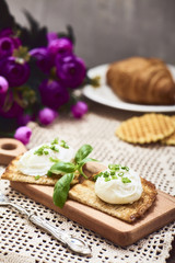 Tasty poached egg on toast over rustic background