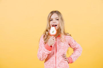 Beautiful cute little girl eat lollipop