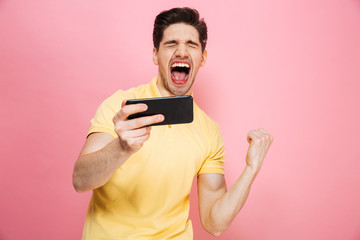 Portrait of a cheerful young man playing games