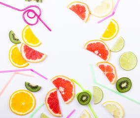 Citrus slices and straws on white background