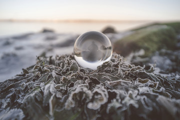 Crystal ball in the nature with a silhouette of a person