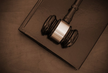 Gavel and legal book on wooden table