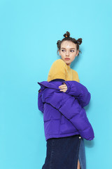 Young fashion woman in short violet down jacket.