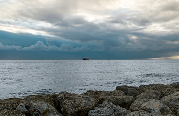 The ocean before the storm with blue clouds 