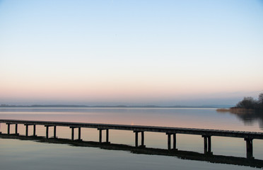 Fototapeta premium Panorama, footbridge, and quiet scene on the lake in the north, Germany