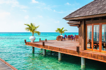 A wooden restaurant on the water against the backdrop of the azure waters of the Indian Ocean, Maldives
