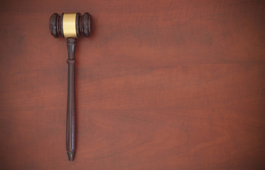 Judge gavel on brown wooden table with copyspace, law concept