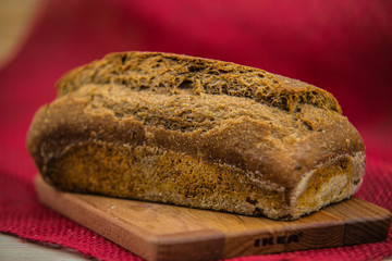 loaf of fresh bread on wooden surface.food closeup.