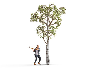 Obraz na płótnie Canvas Young man with an axe cutting a tree