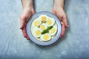tasty boiled eggs over rustic background