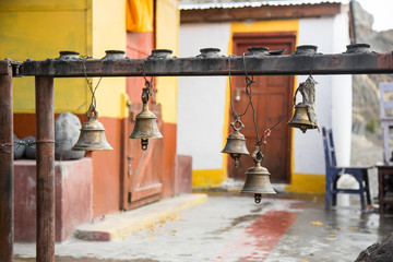 Prayer's bells hanging outside of Kagbeni buddhist temple, Annapurna circuit, Nepal, Himalayas. Aum...
