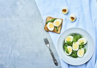tasty boiled eggs over rustic background
