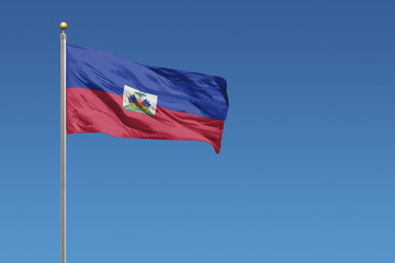 Flag of Haiti in front of a clear blue sky
