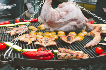 meat and fresh vegetables are cooked on open fire. the concept of a family holiday outdoors. Barbecue for Independence Day