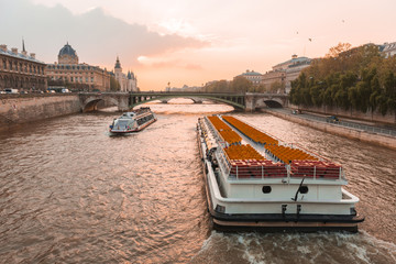 Sunset river sena paris, with boats and bridges in the background