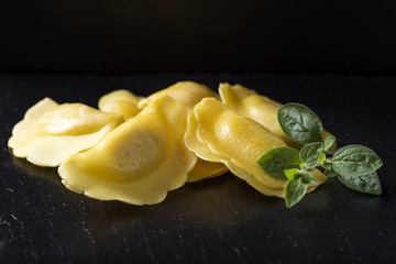 Close up of some uncooked ravioli stuffed with meat