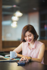 business woman working with calculator at office	