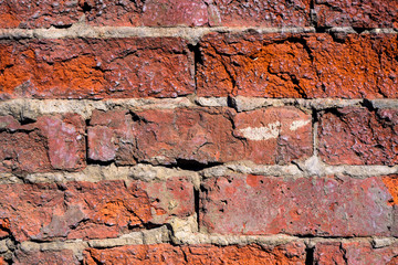 Abstract texture broken brick wall red color close-up