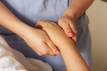 Fototapeta na wymiar woman's hand massage in spa club