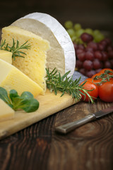 Cheeses with basil, rosemary, tomatoes and grapes.