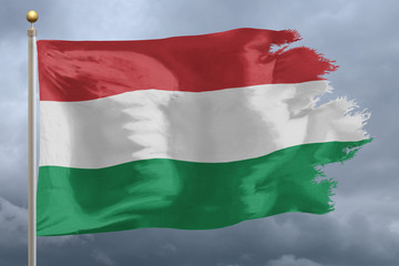 Hungary Flag with torn edges in front of a stormy sky