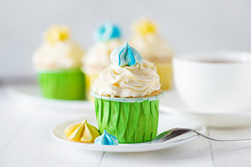 A sunny morning ladies breakfast tea with home cupcake with meringues. Good morning concept.