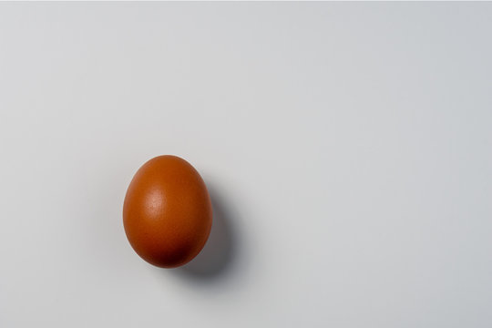 Minimalism. one rustic egg on third image on white background with soft shadows and copy space
