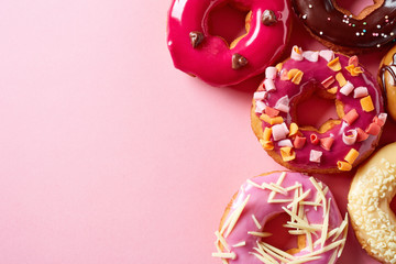 Donuts on pink background, from above