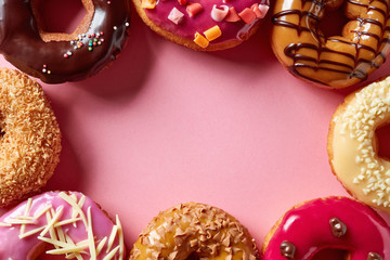 Donuts on pink background, from above