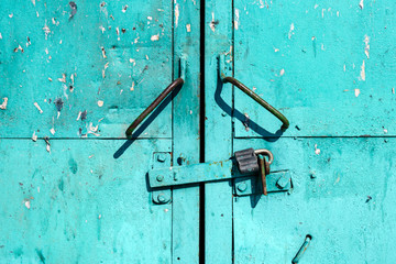 Close-up of handles from old metal green doors