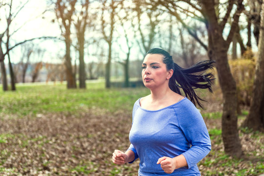 Portrait of young woman running