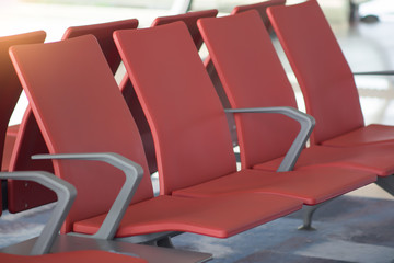 Row of empty red chairs at airport