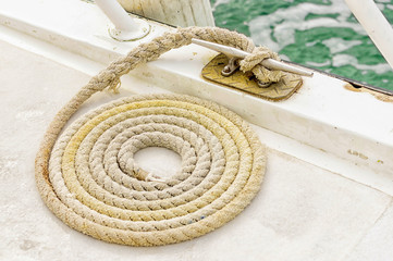 The rope rope is neatly folded on the ship's deck
