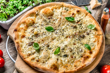 Pizza four cheeses on the table