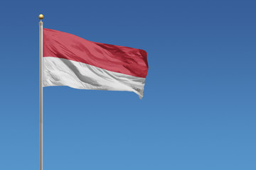 Fototapeta na wymiar Flag of Indonesia in front of a clear blue sky