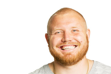 Obraz premium Cute young man with a beard laughing, close-up, isolated