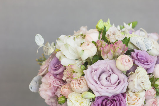 The delicate rustic floral bouquet of rose lilac peony on grey background