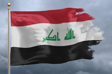 Iraq Flag with torn edges in front of a stormy sky