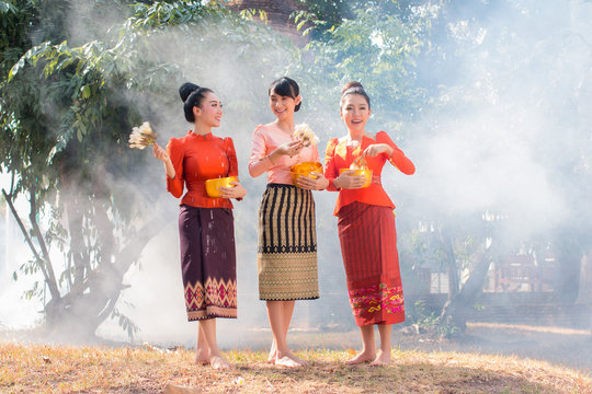 Beautiful Thai girl in Thai costume playing water in Songkran day.