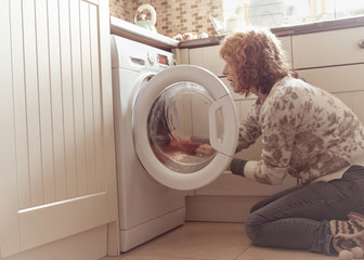 People,Woman emptying washing machine laundry