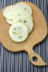 Sliced onion on a wooden kitchen cutting board