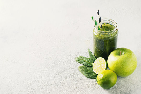Green smoothie with ingredients, apples, lime, broccoli and spinach. Clean eating
