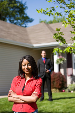 Home: Woman With Real Estate Agent Behind