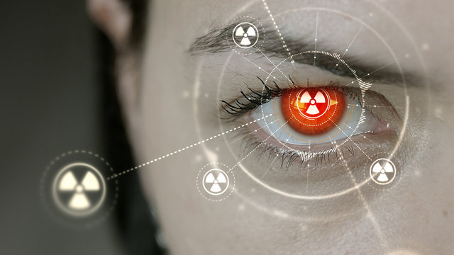 Young cyborg female blinks then nuclear symbols appears.