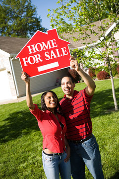 Home: Couple Holds Up For Sale Sign