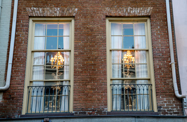 Windows framing warm interiors in New orleans