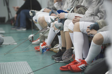 Legs of young participants of fencing competition