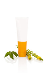 Agrimonia creme in tube with plant isolated on white.