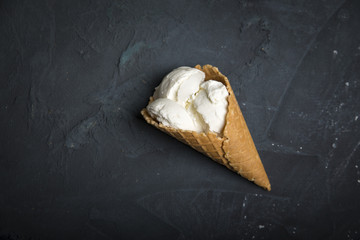 Variety of ice cream scoops in cones with chocolate, vanilla and strawberry