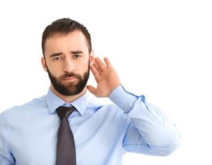 Young man with hearing problem on white background